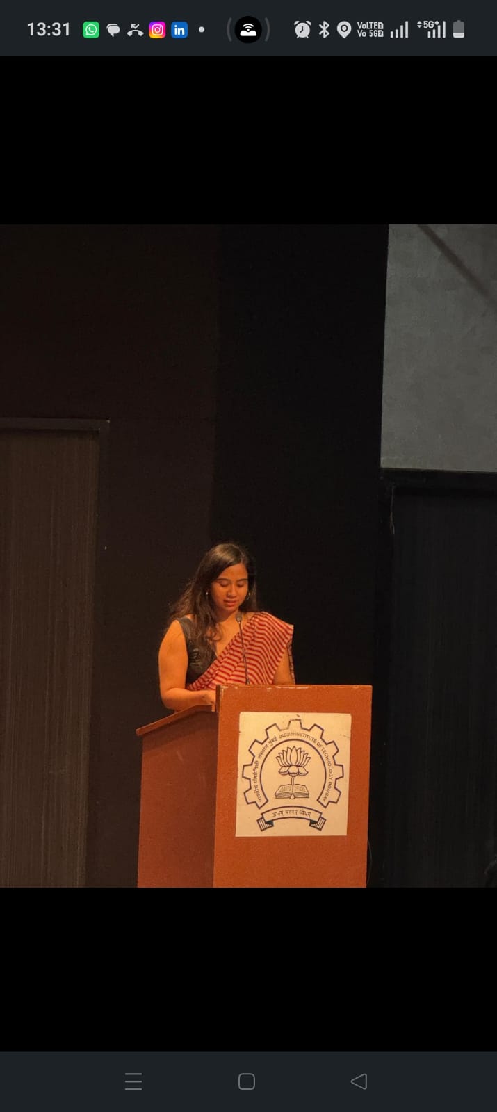 Speaker addressing an academic audience from the podium